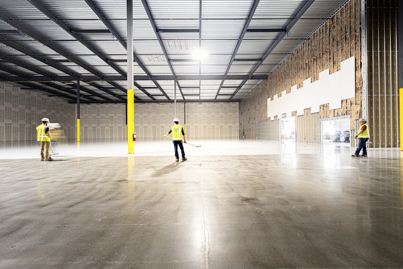 Construction workers inspecting a commercial retail shell during shop fit-out delivery
