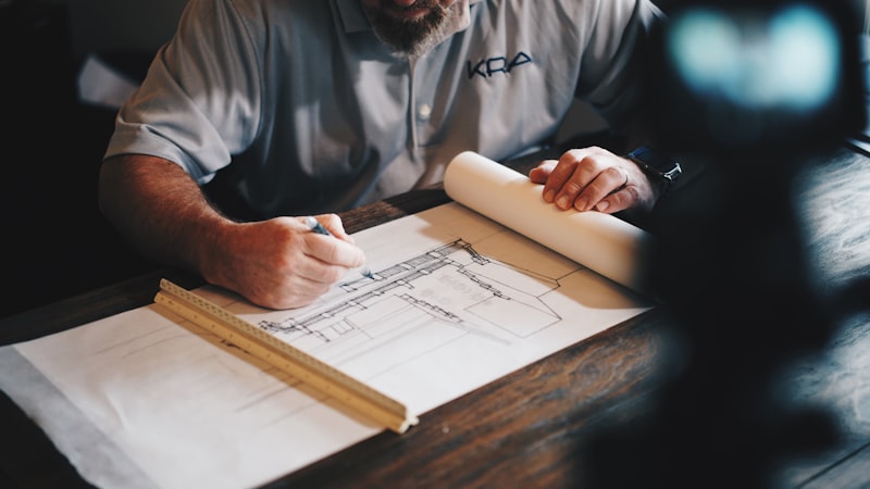 Architect reviewing detailed building cross-section plans on a construction project